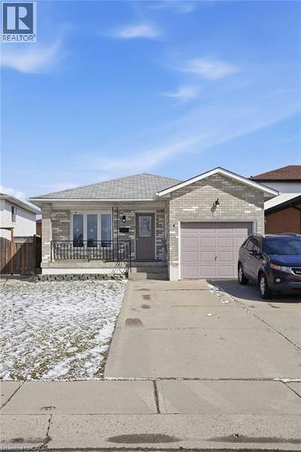Single story home featuring driveway, brick siding, and a garage - 513 Rexford Drive, Hamilton, ON - Outdoor