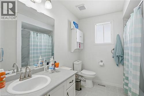 Full bath featuring vanity, light tile patterned flooring, and curtained shower - 513 Rexford Drive, Hamilton, ON - Indoor Photo Showing Bathroom
