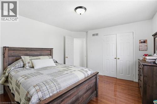 Bedroom featuring dark wood-type flooring and a closet - 513 Rexford Drive, Hamilton, ON - Indoor Photo Showing Bedroom