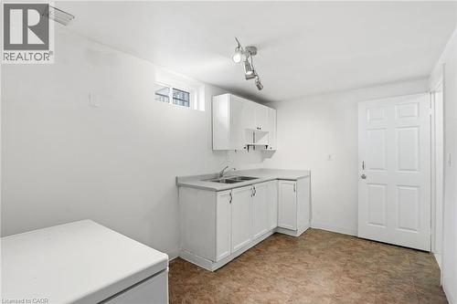 Kitchen with white cabinets and light countertops - 513 Rexford Drive, Hamilton, ON - Indoor