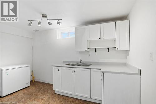 Kitchen with white cabinets, light countertops, and open shelves - 513 Rexford Drive, Hamilton, ON - Indoor