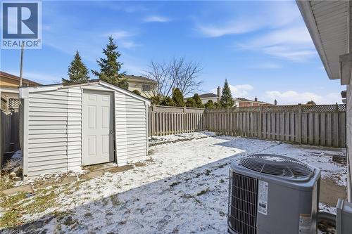 Snowy yard featuring a fenced backyard and a shed - 513 Rexford Drive, Hamilton, ON - Outdoor