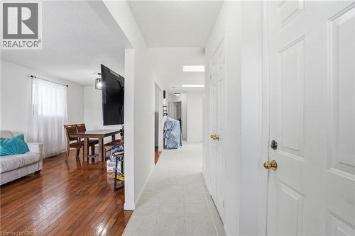 Hall featuring light wood-style floors and baseboards - 513 Rexford Drive, Hamilton, ON - Indoor Photo Showing Other Room