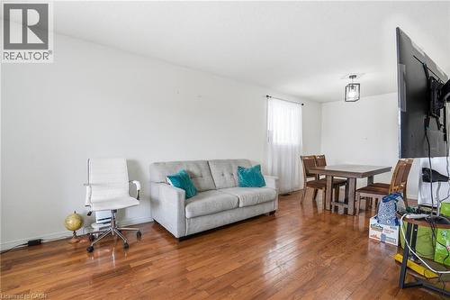 Living area featuring wood-type flooring and baseboards - 513 Rexford Drive, Hamilton, ON - Indoor Photo Showing Living Room