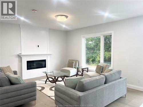 33 Eagle, Leamington, ON - Indoor Photo Showing Living Room With Fireplace