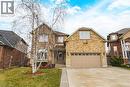 View of front facade with driveway, a front yard, a garage, and brick siding - 120 Valiant Circle, Hamilton, ON  - Outdoor 