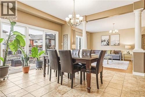 Dining space featuring hanging lights, healthy amount of natural light, and ornate columns - 120 Valiant Circle, Hamilton, ON - Indoor Photo Showing Dining Room