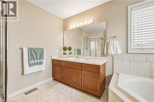 Full bathroom with vanity, a stall shower, light tile patterned floors, and a bath - 120 Valiant Circle, Hamilton, ON - Indoor Photo Showing Bathroom
