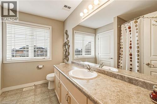 Full bath featuring a shower with curtain, vanity, and light tile patterned flooring - 120 Valiant Circle, Hamilton, ON - Indoor Photo Showing Bathroom
