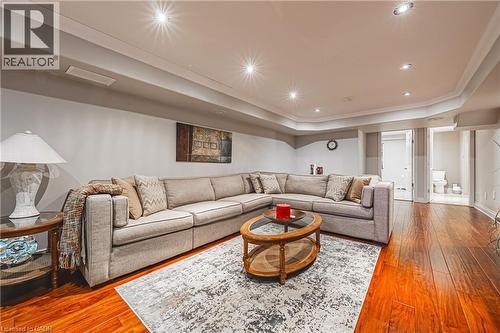 Living room featuring wood-type flooring, a raised ceiling, crown molding, and recessed lighting - 120 Valiant Circle, Hamilton, ON - Indoor Photo Showing Living Room