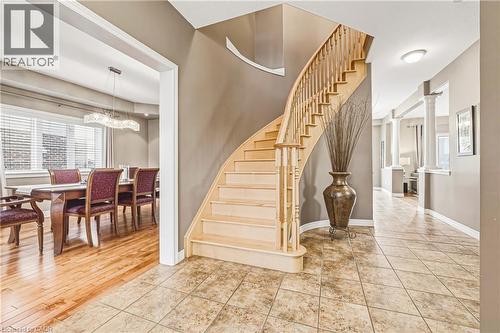 Stairs featuring healthy amount of natural light, ornate columns, and tile patterned flooring - 120 Valiant Circle, Hamilton, ON - Indoor Photo Showing Other Room