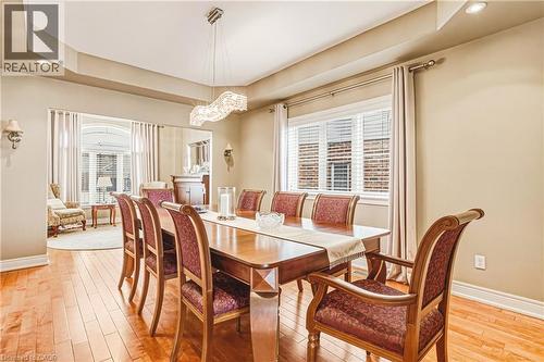 Dining room with light wood-style flooring, recessed lighting, and a tray ceiling - 120 Valiant Circle, Hamilton, ON - Indoor Photo Showing Dining Room