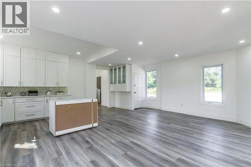 Kitchen with open floor plan, light countertops, backsplash, a kitchen island, and dark wood-type flooring - 1411 E 56 Highway, Glanbrook, ON - Indoor Photo Showing Kitchen