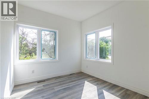 Unfurnished room featuring wood finished floors - 1411 E 56 Highway, Glanbrook, ON - Indoor Photo Showing Other Room