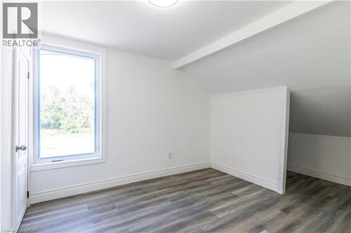 Additional living space featuring dark wood-style floors and lofted ceiling with beams - 1411 E 56 Highway, Glanbrook, ON - Indoor Photo Showing Other Room