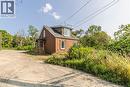 View of property exterior featuring driveway and brick siding - 1411 E 56 Highway, Glanbrook, ON  - Outdoor 