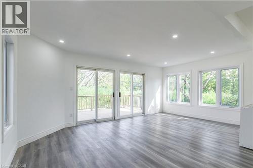 Unfurnished living room with dark wood finished floors and recessed lighting - 1411 E 56 Highway, Glanbrook, ON - Indoor Photo Showing Other Room