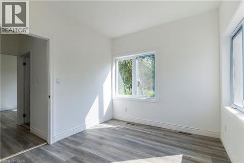 Unfurnished room with wood finished floors and baseboards - 1411 E 56 Highway, Glanbrook, ON - Indoor Photo Showing Other Room