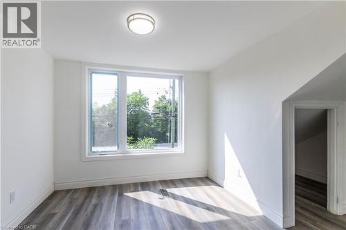 Unfurnished room with light wood finished floors and baseboards - 1411 E 56 Highway, Glanbrook, ON - Indoor Photo Showing Other Room