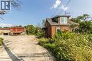 View of property exterior with brick siding, driveway, and roof with shingles - 1411 E 56 Highway, Glanbrook, ON  - Outdoor 