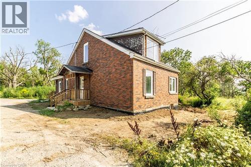 View of property exterior featuring brick siding - 1411 E 56 Highway, Glanbrook, ON - Outdoor With Exterior