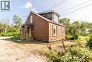 View of property exterior featuring brick siding - 1411 E 56 Highway, Glanbrook, ON  - Outdoor With Exterior 