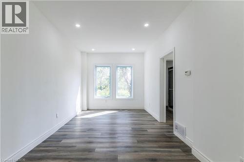 Empty room featuring dark wood-type flooring and recessed lighting - 1411 E 56 Highway, Glanbrook, ON - Indoor Photo Showing Other Room