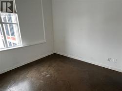 Unfurnished room with baseboards and concrete floors - 
