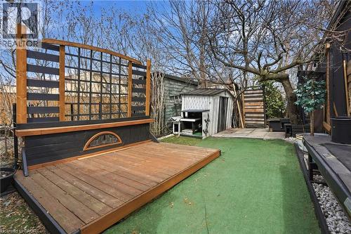 Wooden terrace with a storage shed and a patio area - 79 Murray Street E, Hamilton, ON - Outdoor With Fireplace
