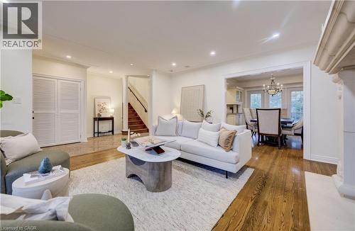 Living room with hardwood / wood-style flooring, a chandelier, and crown molding - 655 Ellengale Road, Burlington, ON - Indoor Photo Showing Living Room