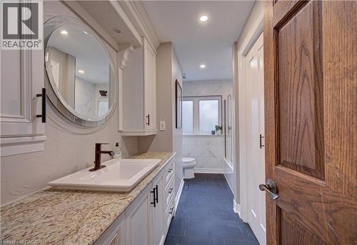 Full bathroom with vanity, shower / bath combination with glass door, dark tile patterned flooring, and recessed lighting - 655 Ellengale Road, Burlington, ON - Indoor Photo Showing Bathroom