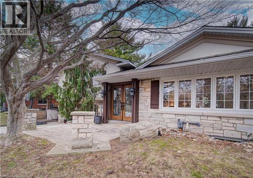 Property entrance featuring a patio area, french doors, and stone siding - 655 Ellengale Road, Burlington, ON - Outdoor
