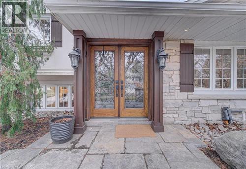 Property entrance featuring stone siding, french doors, and a porch - 655 Ellengale Road, Burlington, ON - 