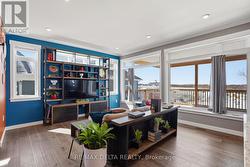 Bright living room overlooks rear patio. - 