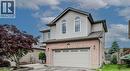 Traditional home with a garage, brick siding, driveway, and a gate - 59 Highgate Road Unit# 1, Kitchener, ON  - Outdoor 