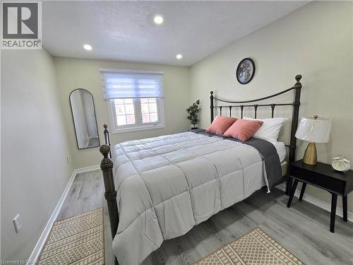 Bedroom featuring light wood-style flooring, recessed lighting, and a textured ceiling - 59 Highgate Road Unit# 1, Kitchener, ON - Indoor Photo Showing Bedroom