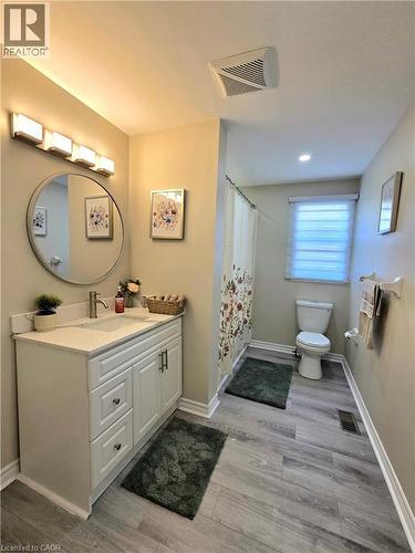 Full bathroom featuring vanity, light wood-style flooring, and a shower with shower curtain - 59 Highgate Road Unit# 1, Kitchener, ON - Indoor Photo Showing Bathroom