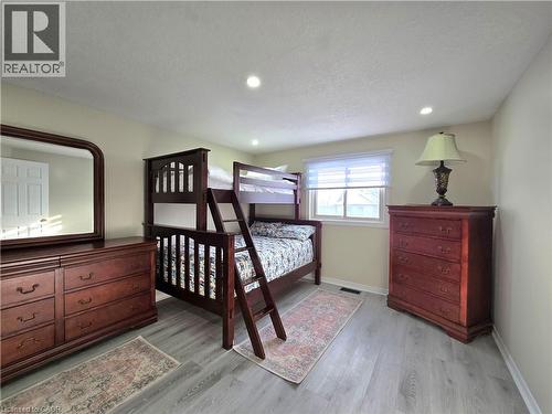 Bedroom featuring light wood-style flooring, recessed lighting, and a textured ceiling - 59 Highgate Road Unit# 1, Kitchener, ON - Indoor Photo Showing Bedroom
