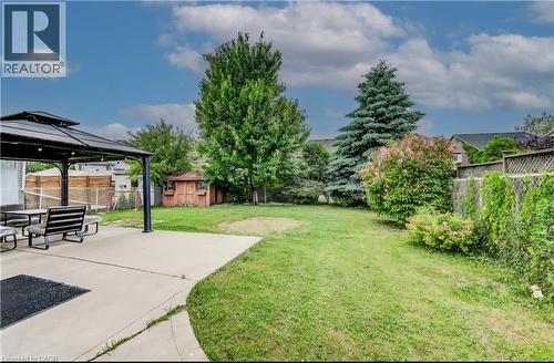 Fenced backyard featuring a gazebo, a shed, and a patio area - 59 Highgate Road Unit# 1, Kitchener, ON - Outdoor