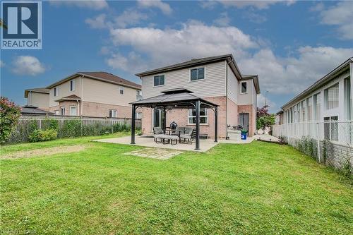 Rear view of property with a gazebo, a patio, brick siding, and a fenced backyard - 59 Highgate Road Unit# 1, Kitchener, ON - Outdoor