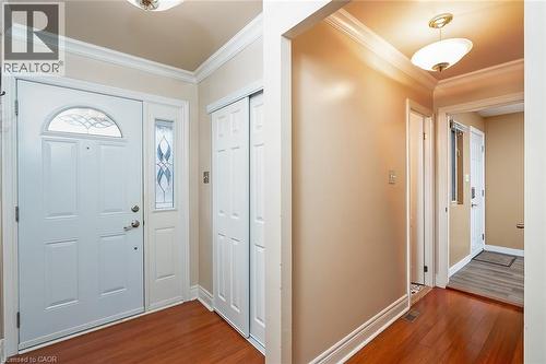 Foyer entrance with crown molding and dark wood finished floors - 1278 Consort Crescent, Burlington, ON - Indoor Photo Showing Other Room