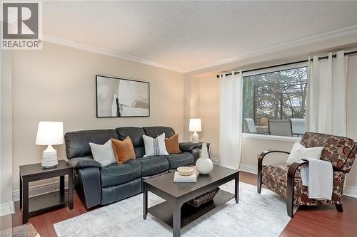 Living area featuring ornamental molding and wood finished floors - 1278 Consort Crescent, Burlington, ON - Indoor Photo Showing Living Room