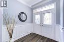 Entrance foyer with ornamental molding, a decorative wall, wainscoting, and dark wood-type flooring - 1406 Marshall Crescent, Milton, ON  - Indoor Photo Showing Other Room 