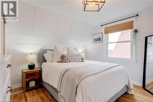 Bedroom with light wood-style floors, vaulted ceiling, and hanging lights - 624 Burgess Avenue, Hamilton, ON - Indoor Photo Showing Bedroom