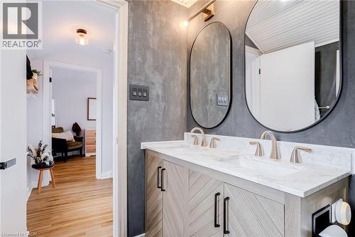 Bathroom featuring double vanity and light wood finished floors - 624 Burgess Avenue, Hamilton, ON - Indoor Photo Showing Bathroom