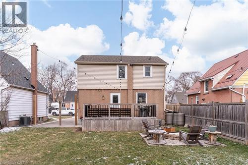 Back of house with a deck, an outdoor fire pit, brick siding, and a patio - 624 Burgess Avenue, Hamilton, ON - Outdoor With Deck Patio Veranda