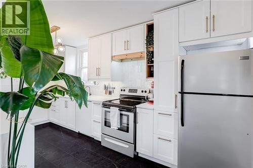 Kitchen featuring stainless steel appliances, white cabinets, and light countertops - 624 Burgess Avenue, Hamilton, ON - Indoor Photo Showing Kitchen