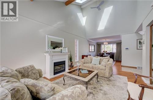 Open concept dining and living. The skylight completements the vaulted ceiling. - 54 Glenwood Drive, Kitchener, ON - Indoor Photo Showing Living Room With Fireplace