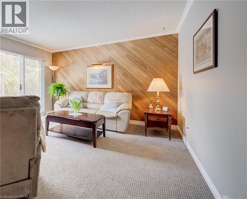 Woodworkers and car enthusiasts! You'll love the fully finished garage with quality cabinets which are included. This is a wide double garage. This spotless space has an epoxy floor! - 54 Glenwood Drive, Kitchener, ON - Indoor Photo Showing Garage