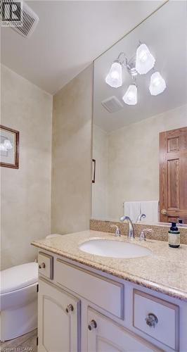 Primary bedroom features hardwood floors, crown molding and an ensuite. - 54 Glenwood Drive, Kitchener, ON - Indoor Photo Showing Bedroom